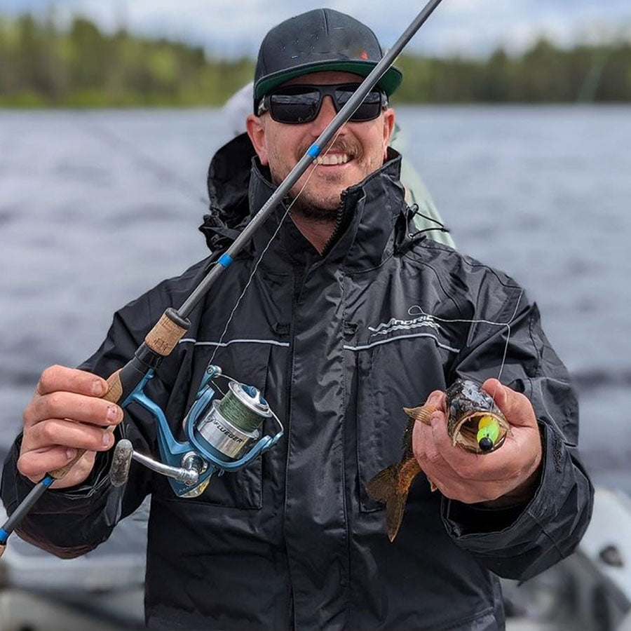 Three-quarter view of waterproof rain gear jacket with hood and storm flaps