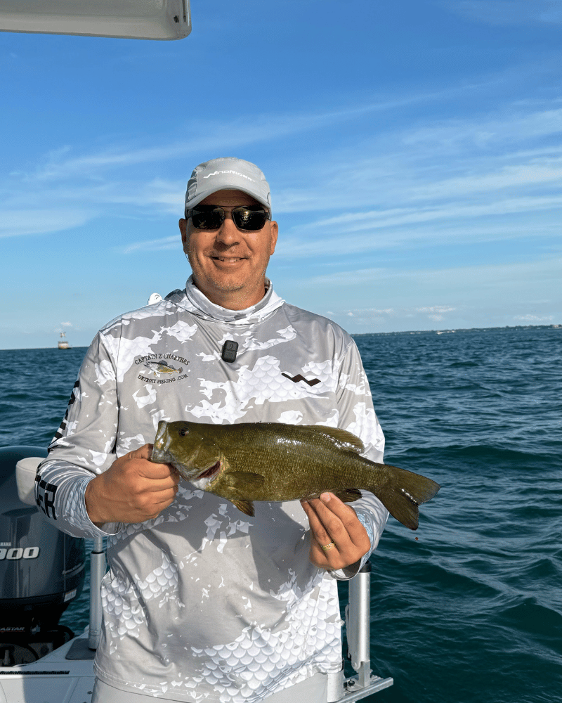 Three-quarter view of grey hooded fishing shirt showing hood design