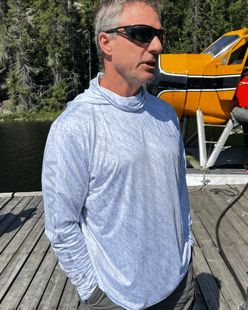 Three-quarter view of grey hooded shirt with hood and gaiter visible