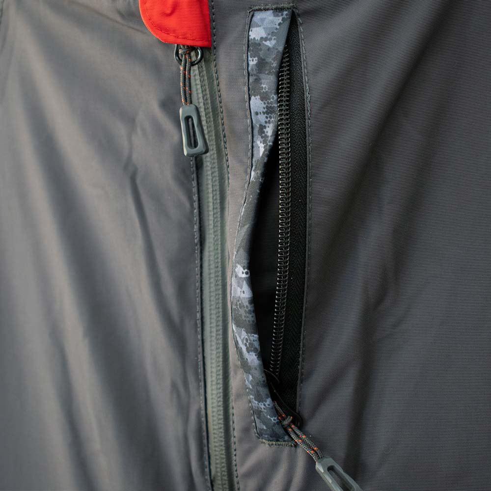 Detail view of charcoal grey ice gear jacket showing insulation and pocket features