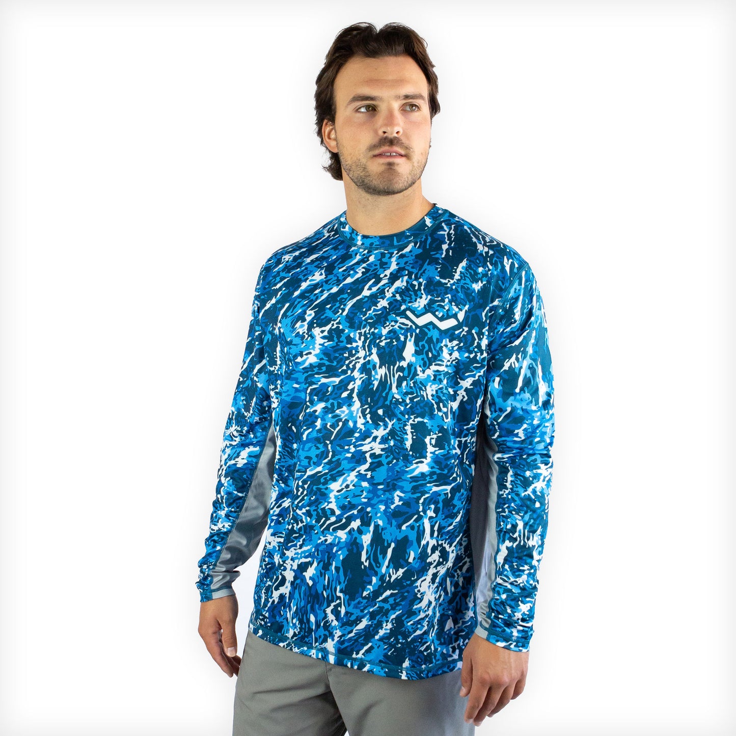 Man in blue camo sol invictus pro shirt front view studio portrait against white background