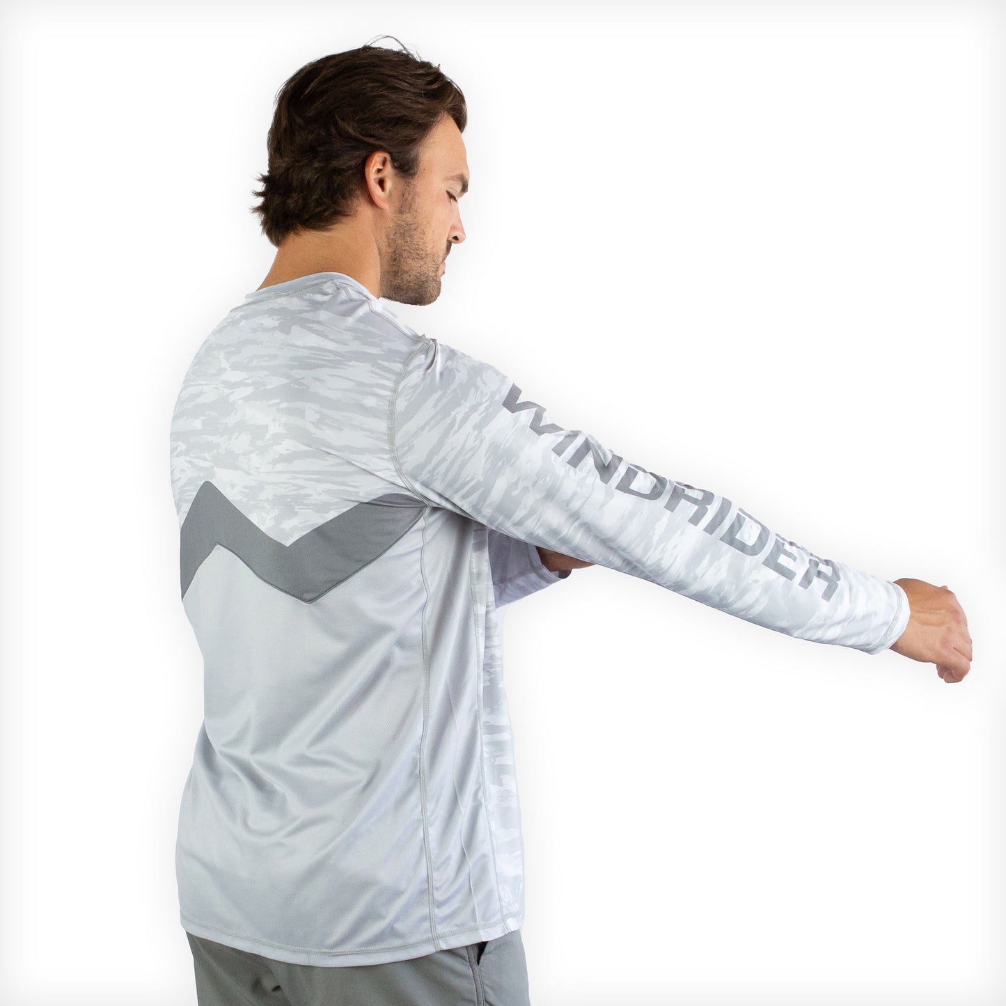 Man in white snowy tundra sol invictus pro shirt studio portrait full body front view