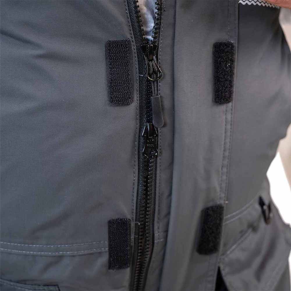 Grey and navy blue waterproof ice gear bibs showing functional design features