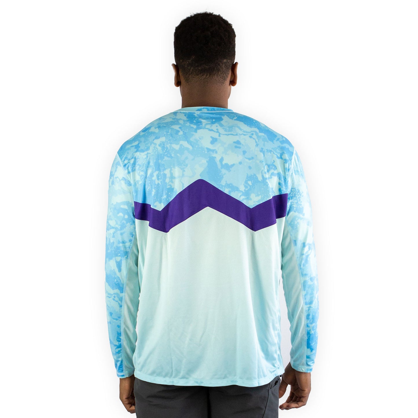 Man in caribbean cove blue sol invictus pro shirt front view studio shot arms at sides