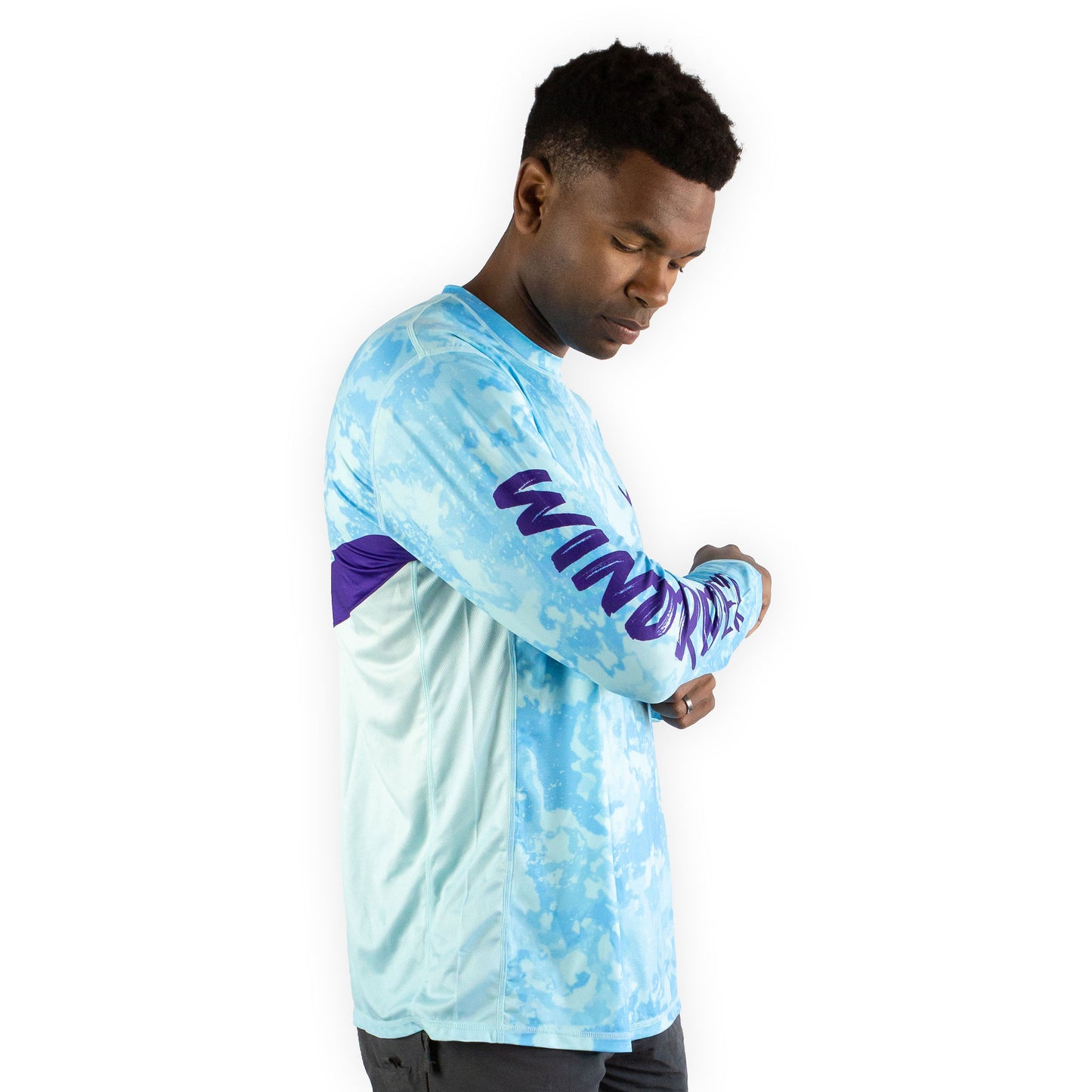 Man in caribbean cove blue sol invictus pro shirt studio shot showing mesh side panels