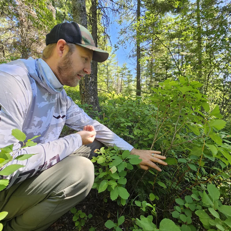 Man in UPF 50+ hooded sun shirt working outdoors in sunny conditions
