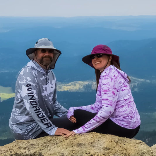 Woman wearing WindRider Women's Helios Hooded Sun Shirt demonstrating UPF 50+ sun protection for outdoor activities