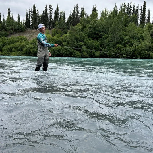 Offshore angler in Helios sun protection shirt with king mackerel catch during trolling run, demonstrating performance fishing apparel