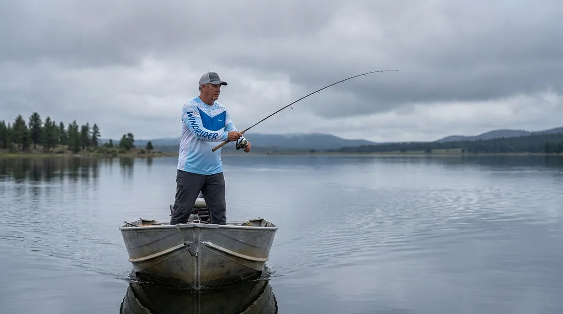 angler casting from a boat on an overcast day, thick grey cloud cover overhead, calm lake water, no visible sun