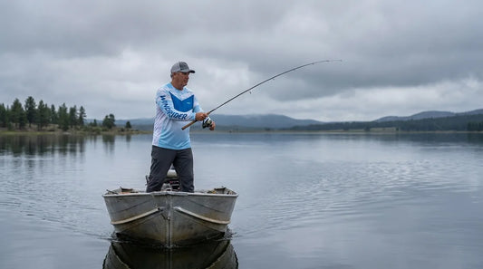 angler casting from a boat on an overcast day, thick grey cloud cover overhead, calm lake water, no visible sun