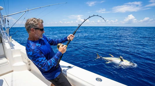 angler on offshore sportfishing boat in blue Gulf Stream water, long-sleeve sun shirt, fighting large yellowfin tuna on bent rod, bright midday sun overhead