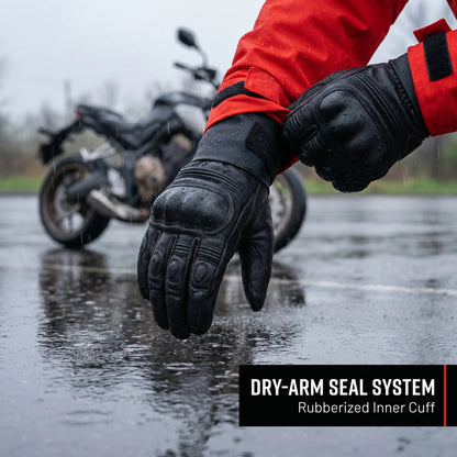 Person wearing black gloves with a motorcycle in the background on a wet road, highlighting a dry-arm seal system feature. [moto-only]