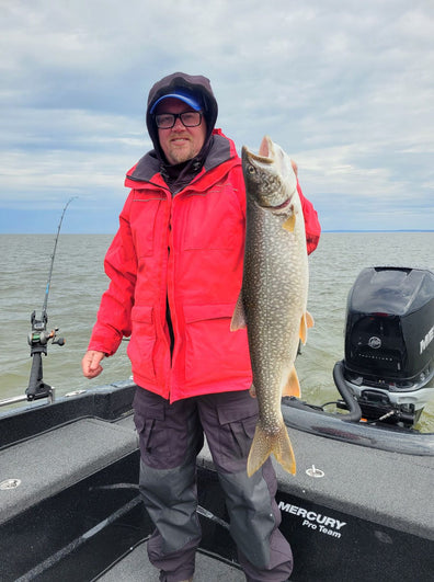 Customer with a lake trout in the red suit