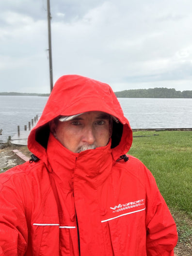 Guide in the red jacket on an overcast lake