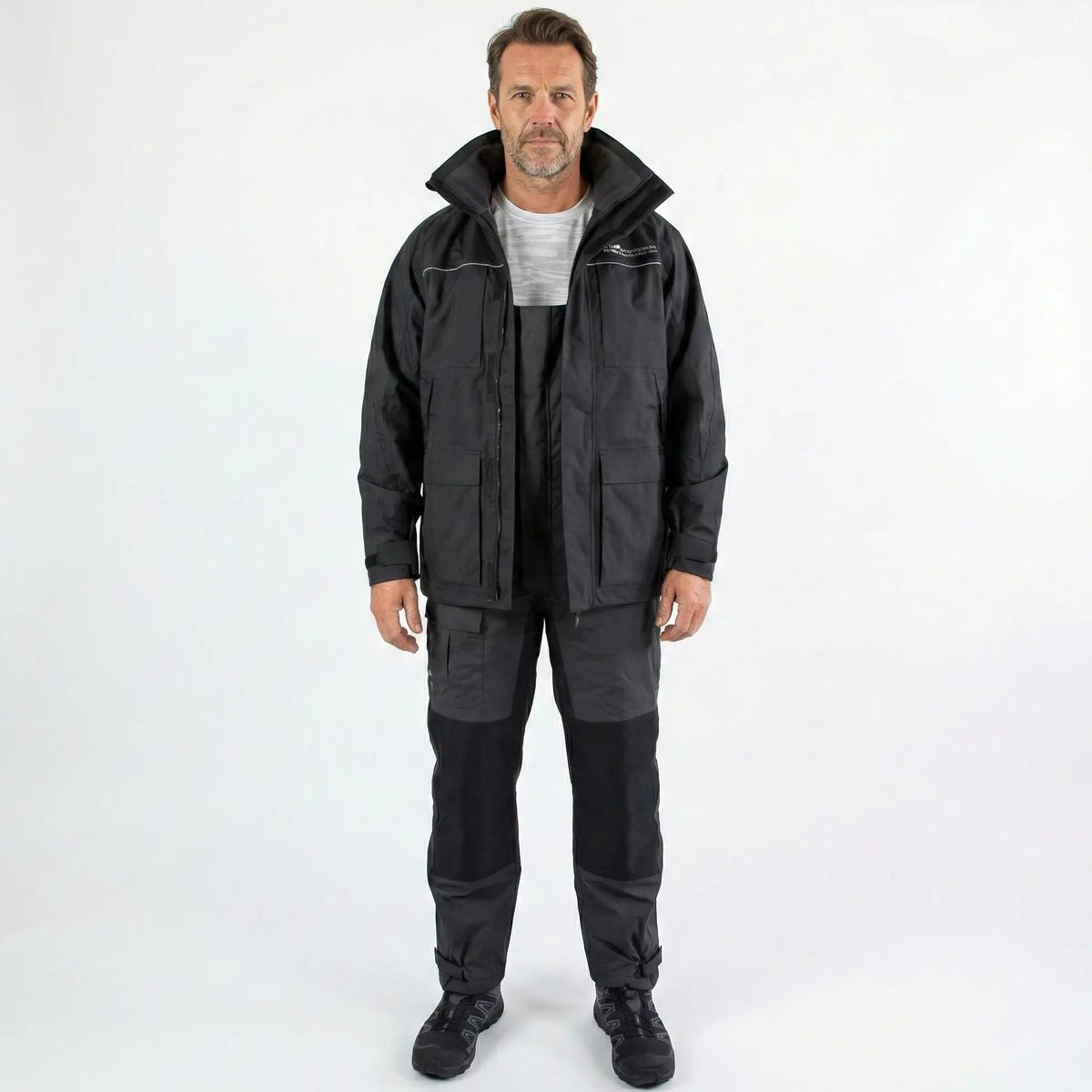 Pro All-Weather Rain Gear Set in black, jacket and bibs shown front-on on a model