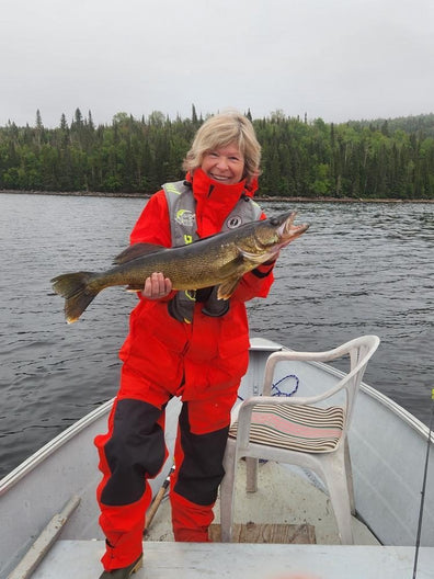 Customer with a walleye in the red suit