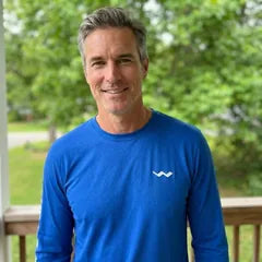 Tom D., the narrator, smiling outdoors.