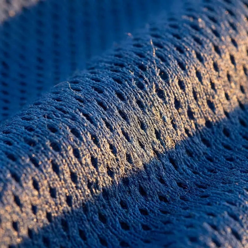 Close-up of the Helios flat-knit fabric with light across the weave.