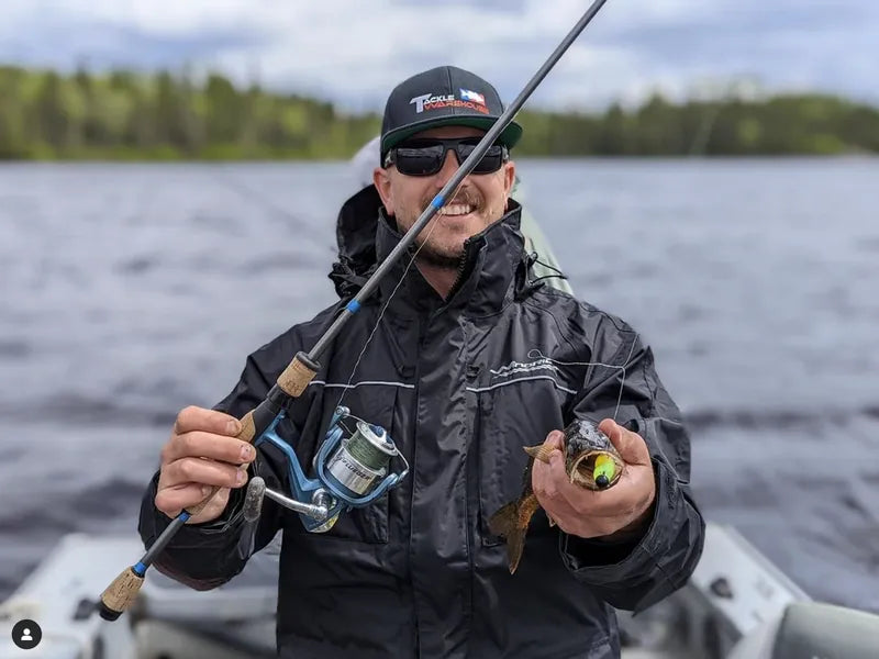 Angler actively fishing while wearing WindRider rain gear in wet conditions