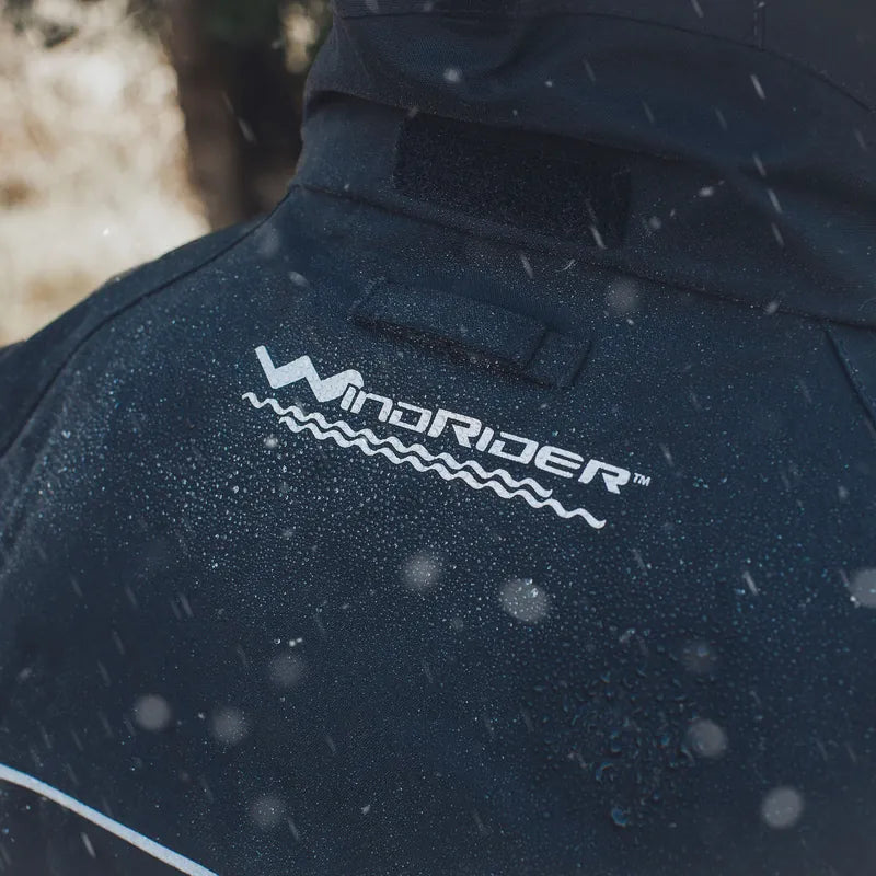 Close-up of WindRider logo with water beading on rain gear fabric