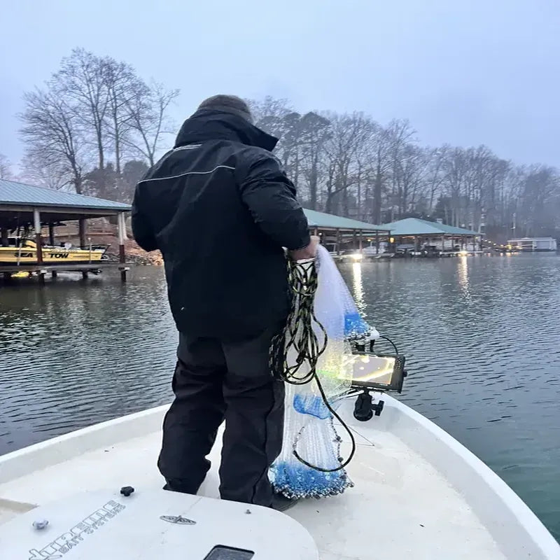 Angler struggling with inadequate rain gear in harsh winter boat conditions